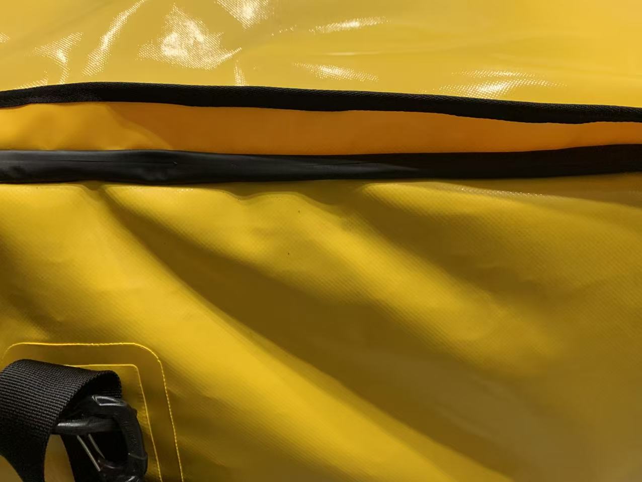 Close-up of RF-welded anchor points and non-reflective stealth hardware on an OEM tactical dry bag.